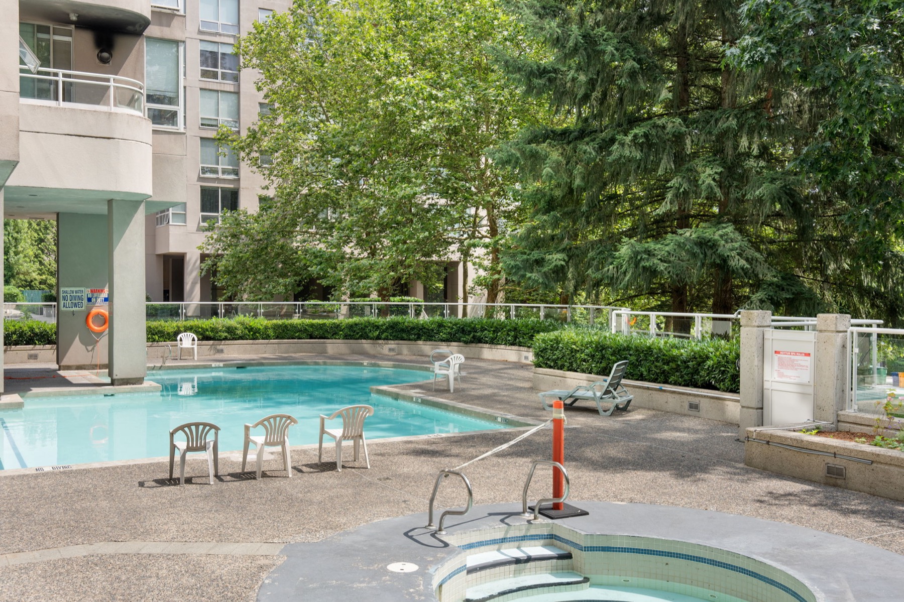 The pool and the whirlpool, lounge chairs on the deck.