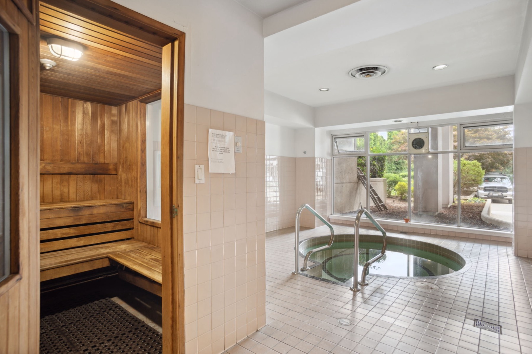 The sauna and the indoor whirlpool beside the window.