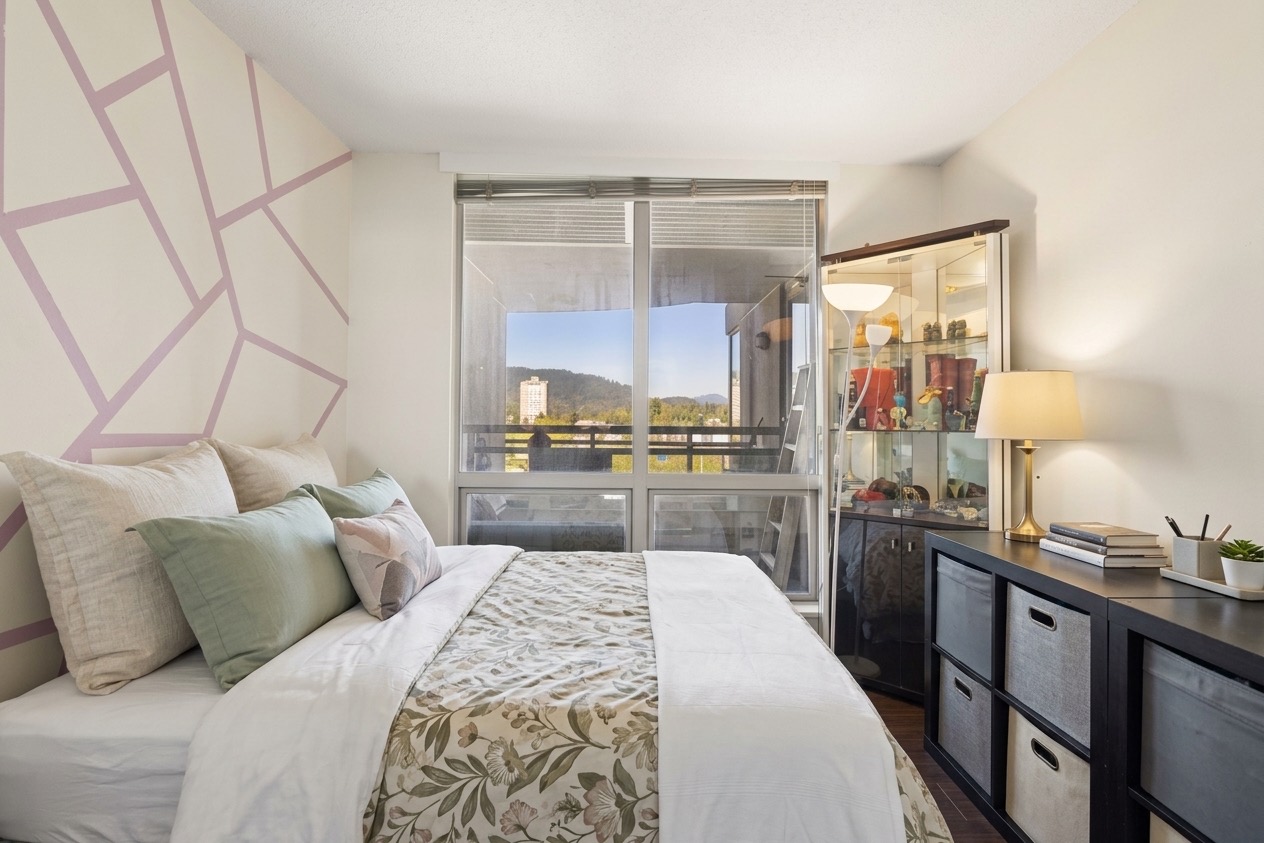 The second bedroom, virtually staged: the bed against a patterned wall with a window to the hills.